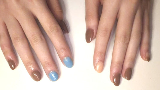 Top-down view of manicured hands with a clean, TPO-free dip powder polish resting on a natural linen background.