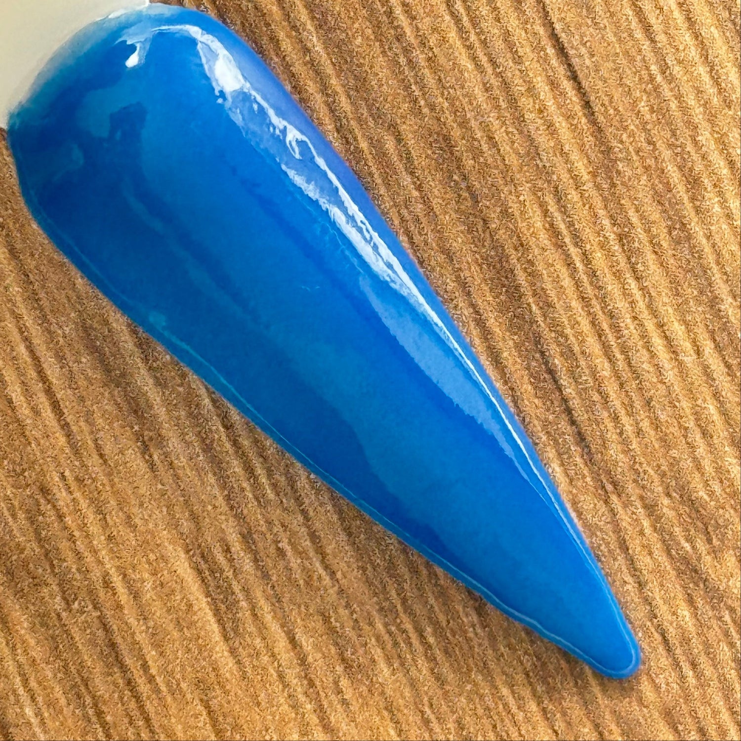Blue dip powder nails in pastel and deep blue tones