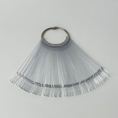 Clear acrylic nail swatch sticks showing various dipping powder and polish colours arranged in a fan displa