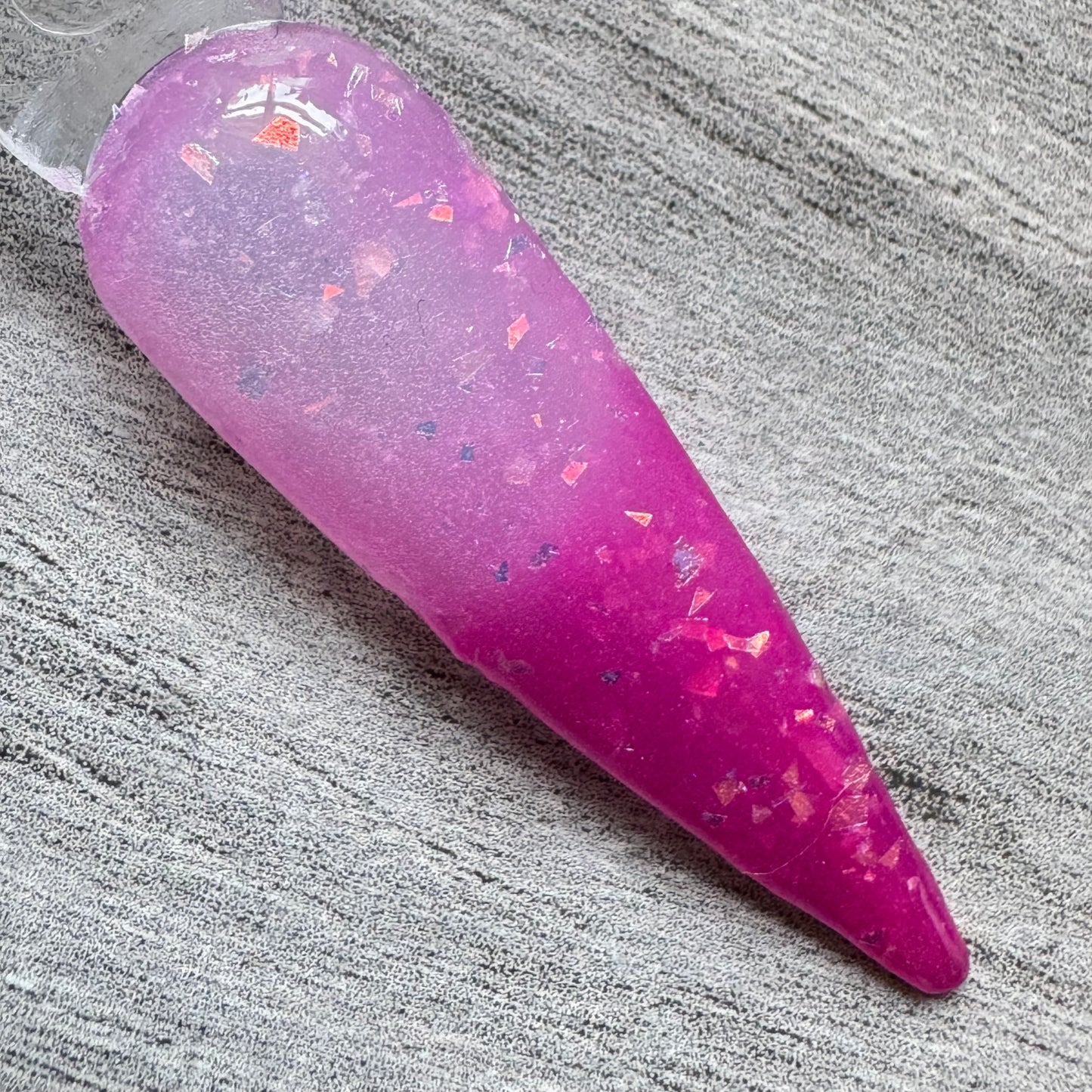 A swatch stick of colour chnaging pink to white thermal dip powder