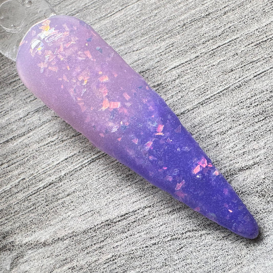 a swatch stick showing the ombre effect of a thermal dip powder colour changing from saphire blue to pink.
